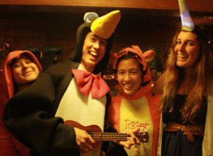 A Cooper playing the ukulele in a penguin suit.
